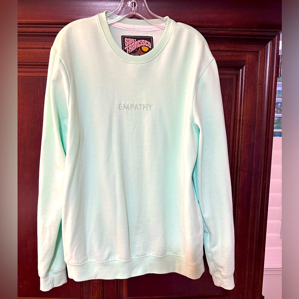 NWOT Sweatshirt that’s has EMPATHY across front